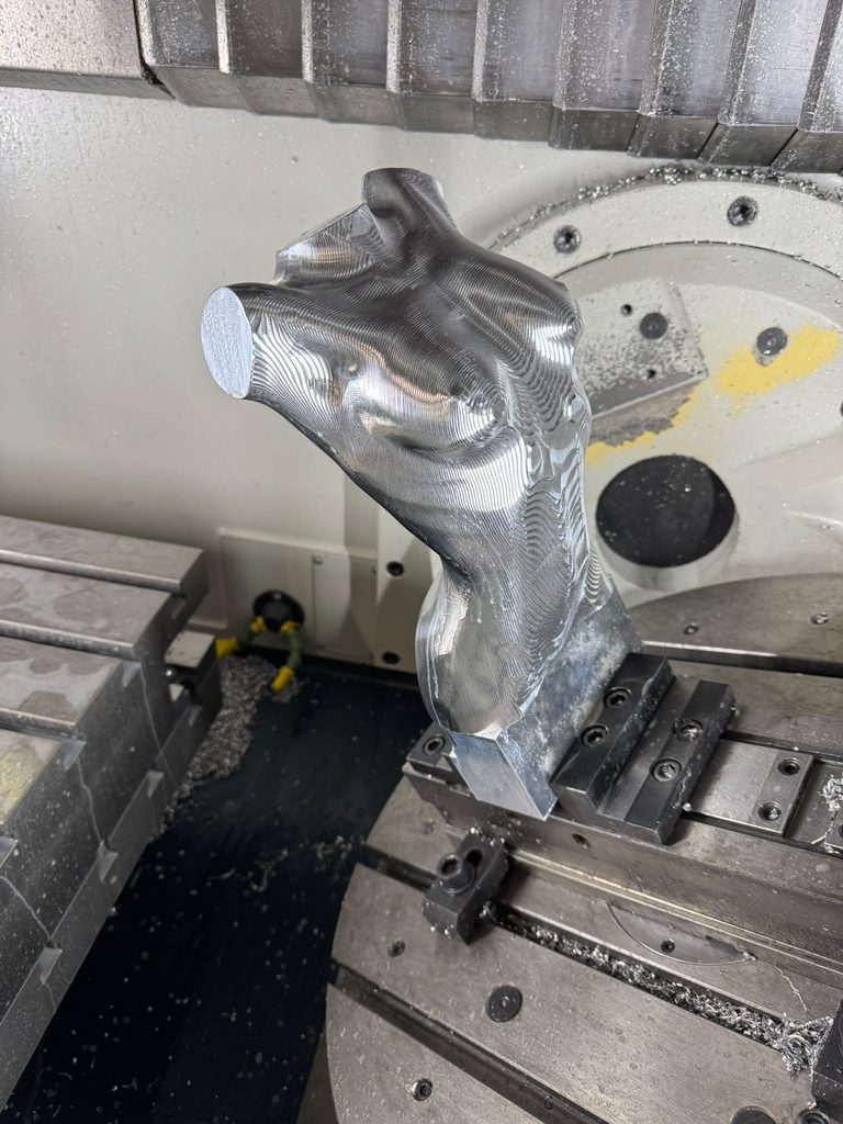 Precision CNC-machined aluminium component during manufacturing.