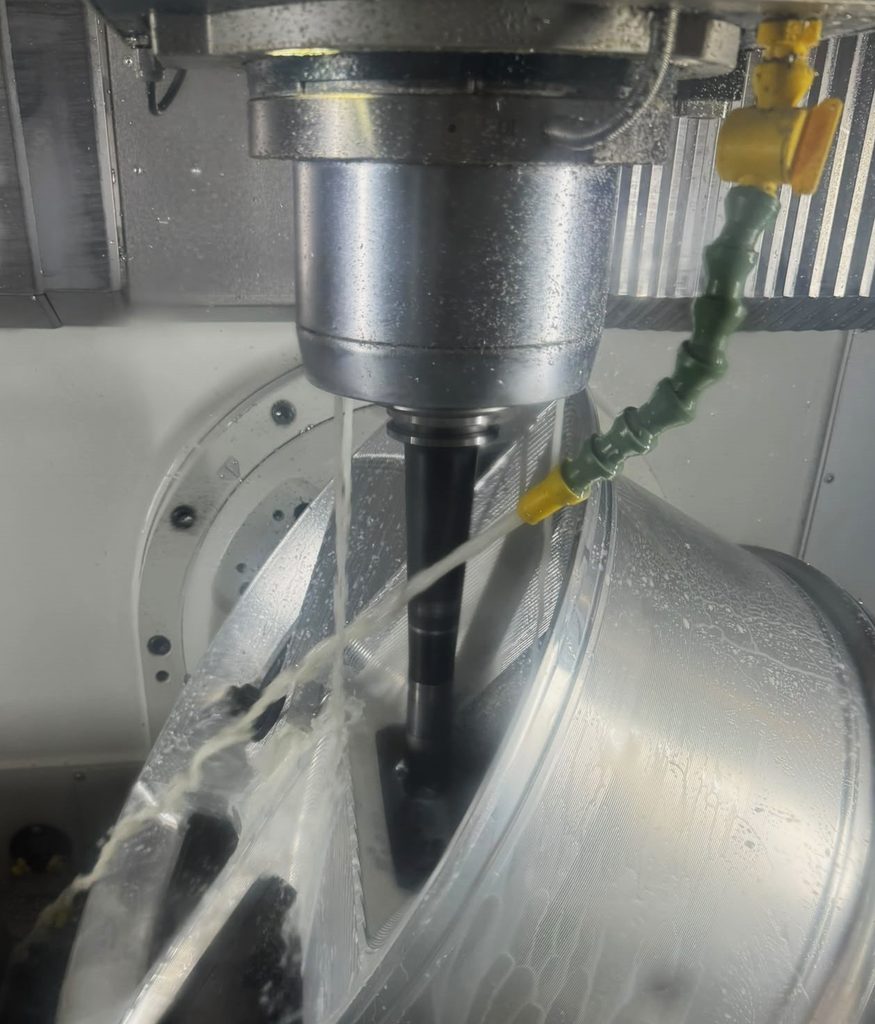 Precision CNC machining in progress on a complex aluminium wheel component